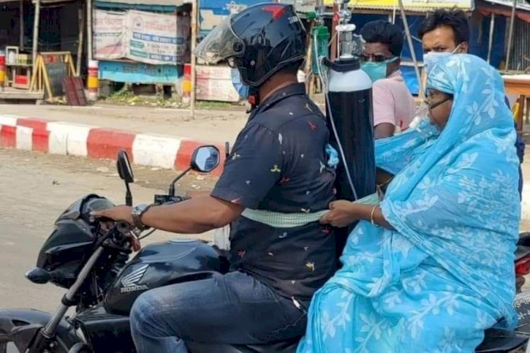 পিঠে অক্সিজেন বেঁধে স্ত্রীকে নিয়ে গেলেন হাসপাতালে